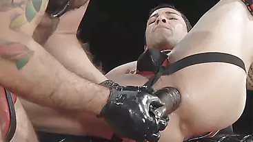 Hunk fucks stud with a toy until he is stretched out