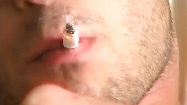 Hottie Cody lights his red cig while stroking his pinkish cock