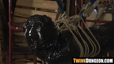 Twink Xavier gets wrapped in plastic by a kink master