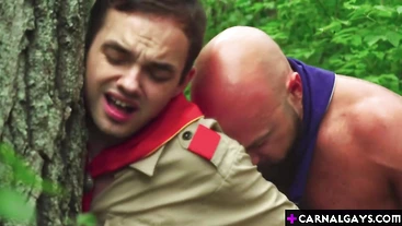 Frustrated scout Marcus Rivers is bent against a tree by Scoutmaster Adam Snow